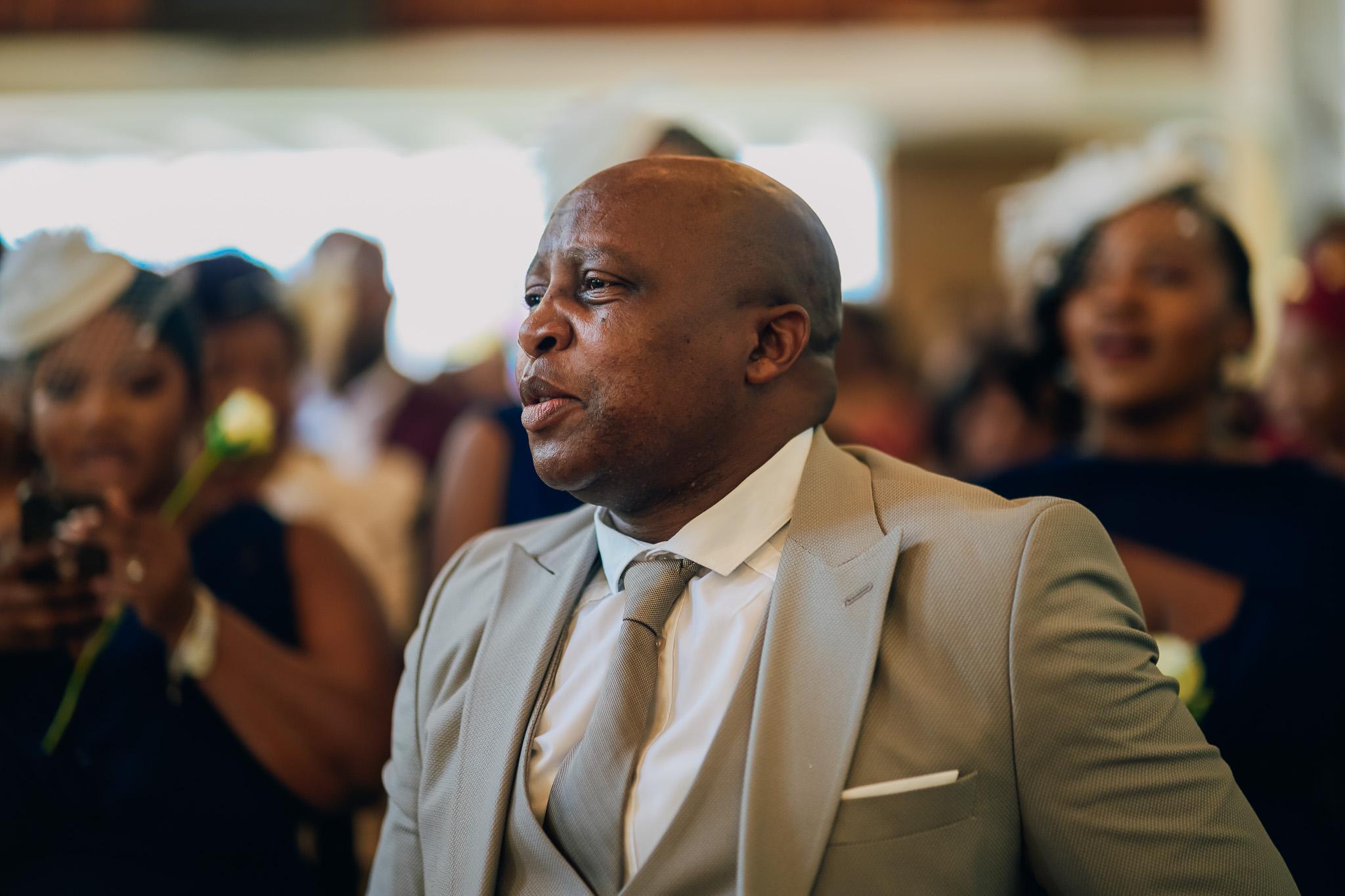 Guest in a grey suit during the church service.