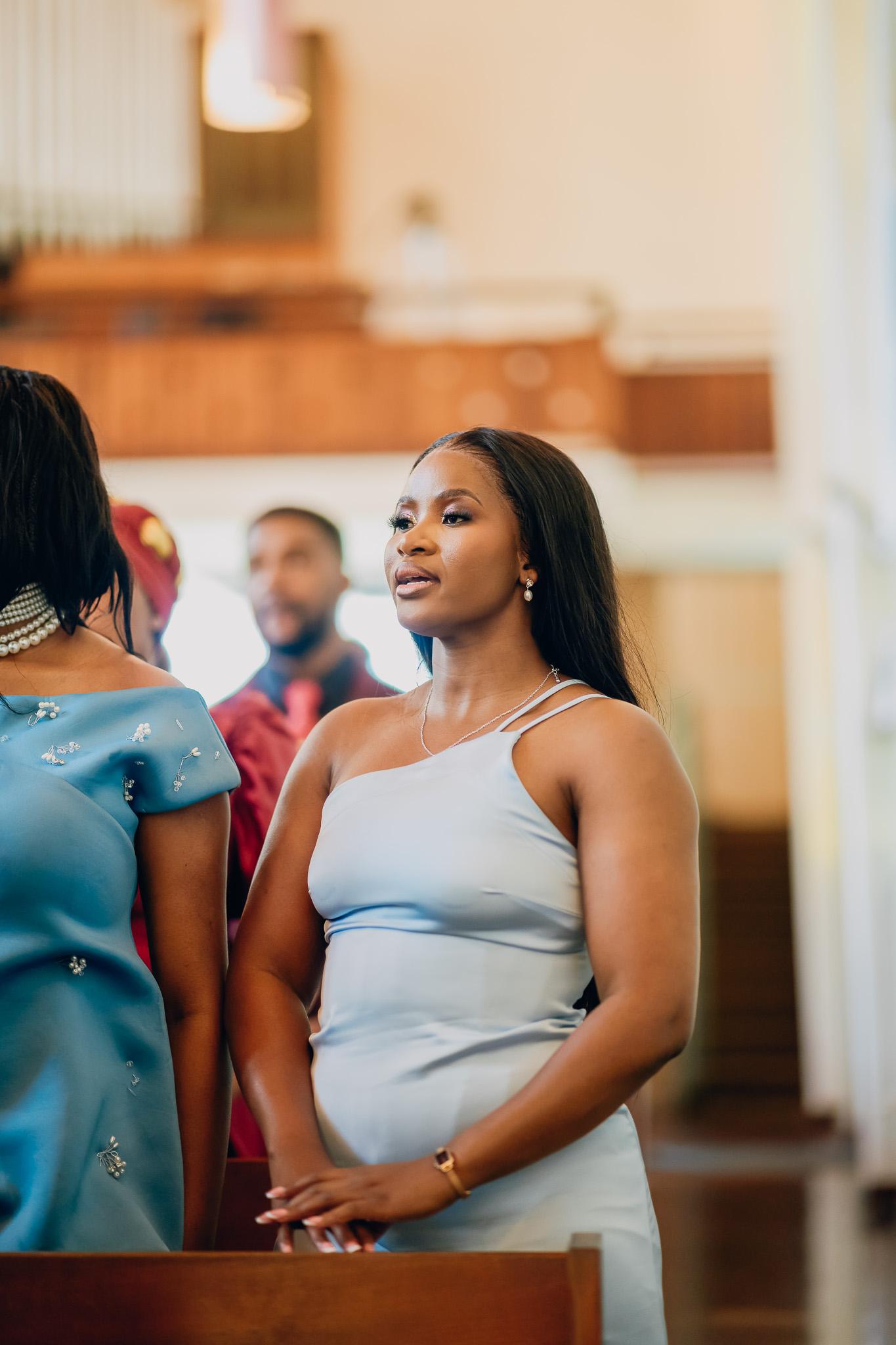 Guest in a pale blue dress during the church service.