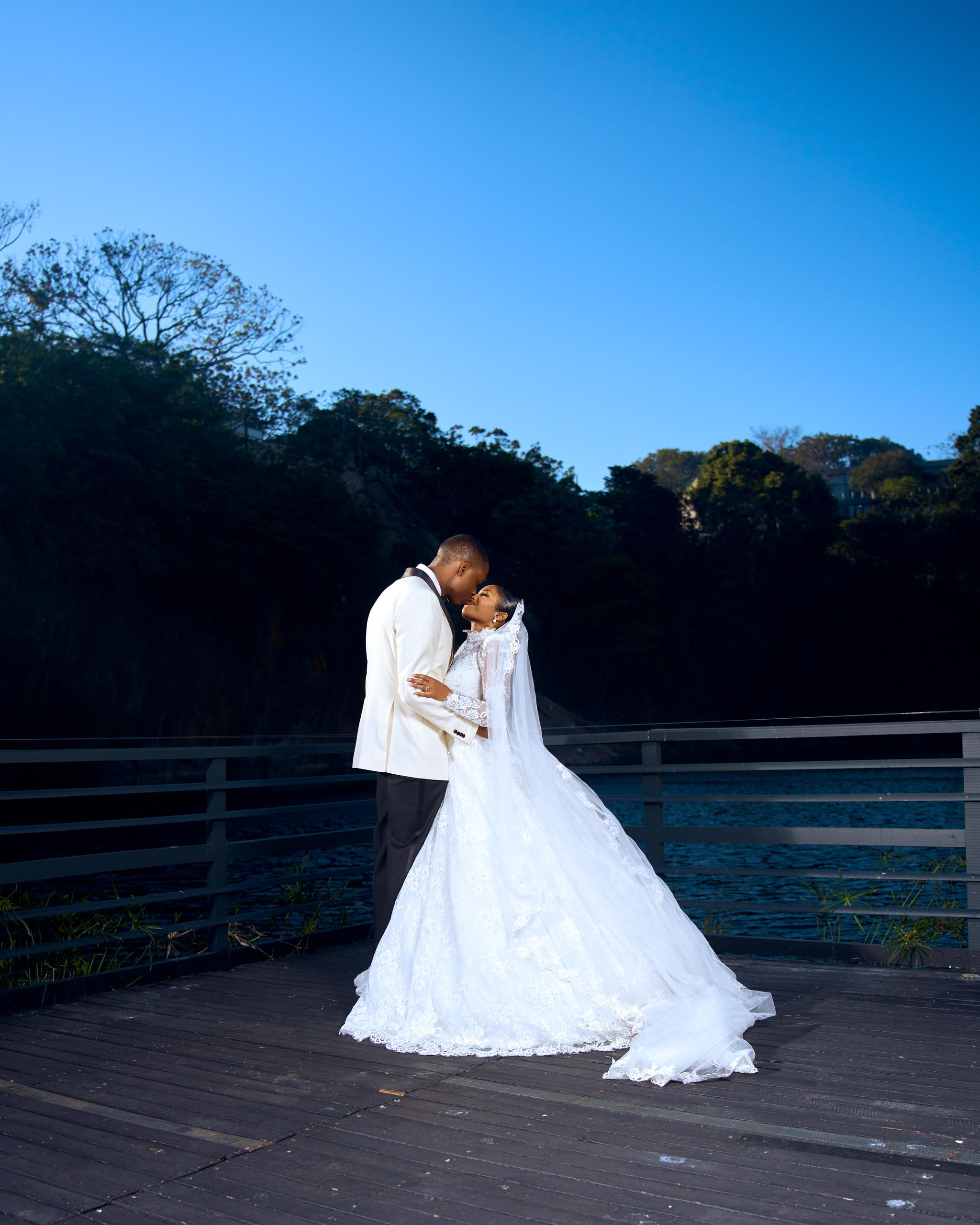 Bride and groom sharing a quiet embrace on the terrace.